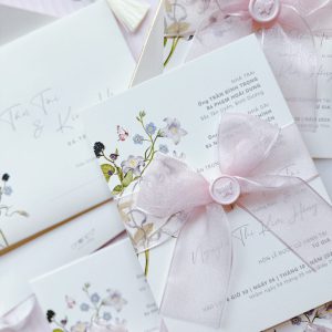 Simple, elegant wedding invitation with pastel pink bow